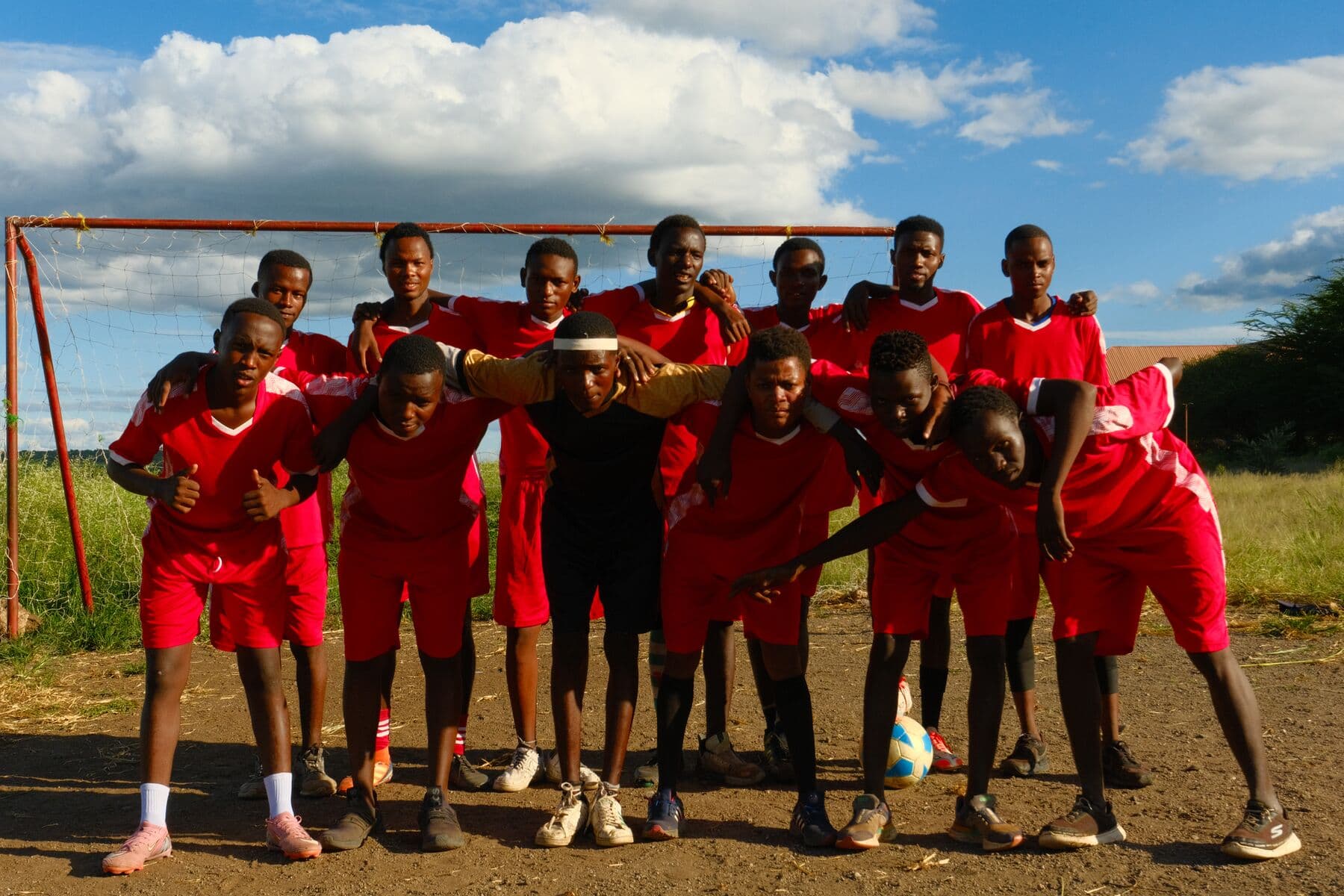 A young football team lined up under the goalposts at Makuyuni.