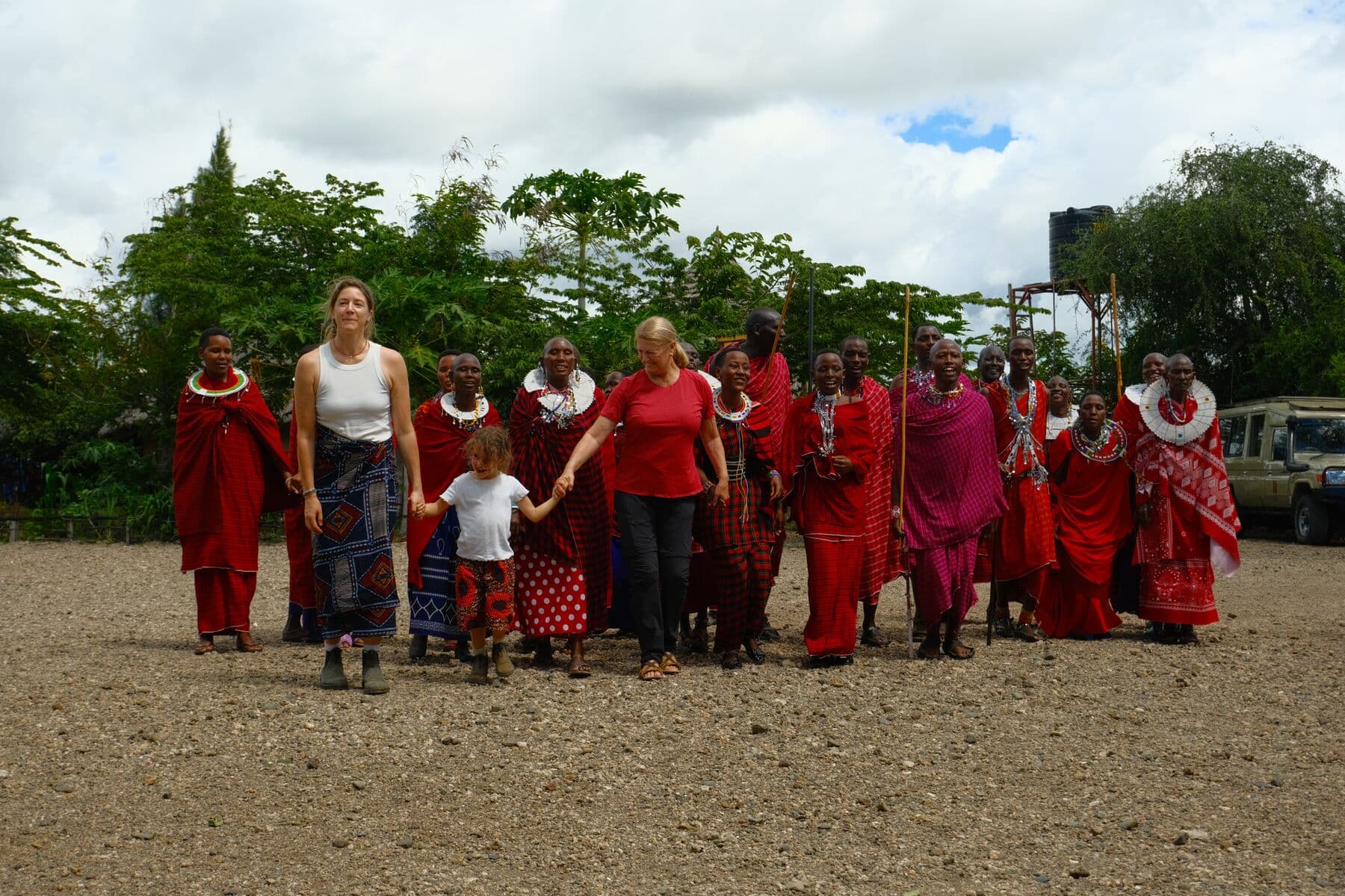 Travellers walking with Maasai hosts through the village at Makuyuni.