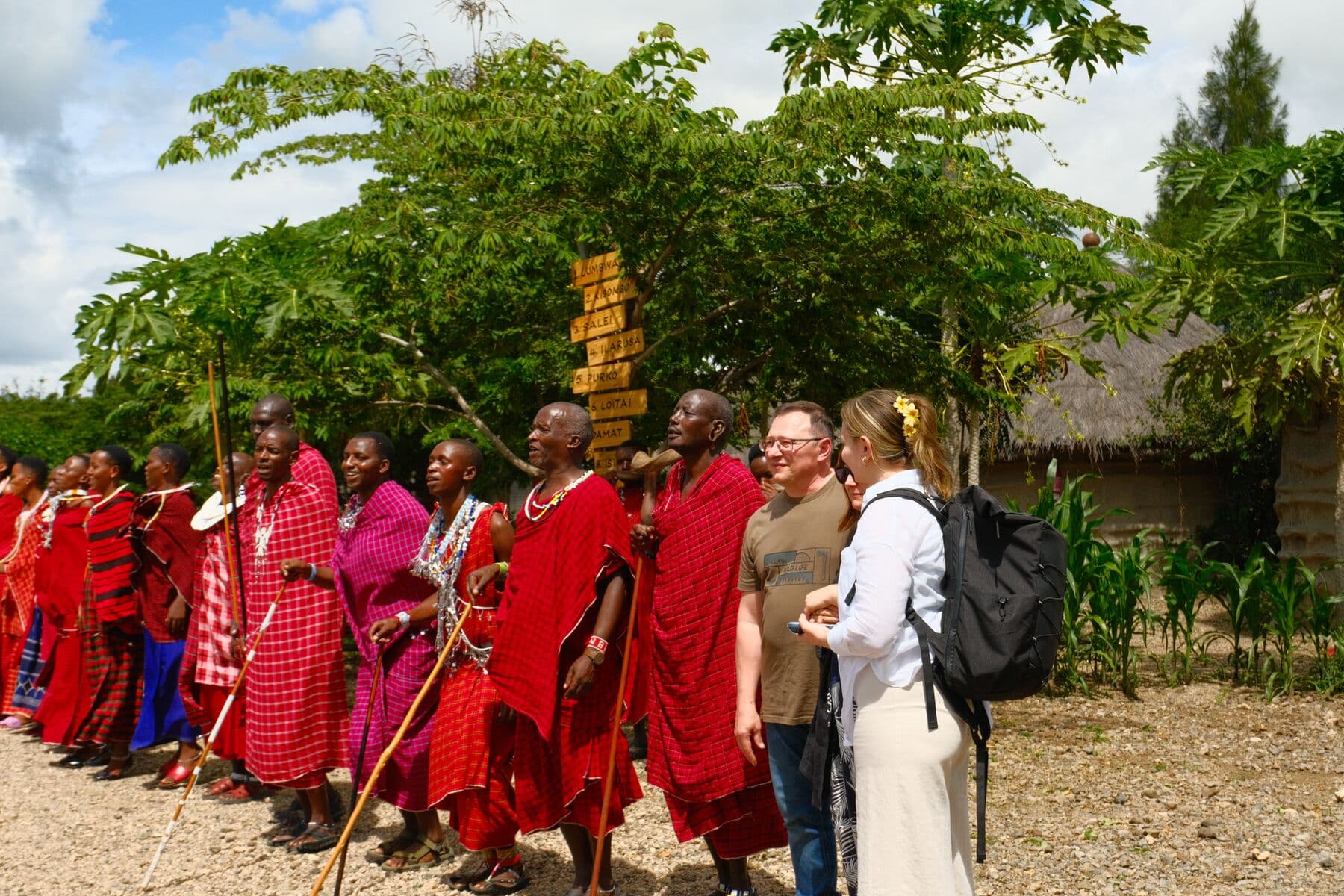 Maasai women and men in red shukas welcome visitors to Makuyuni.